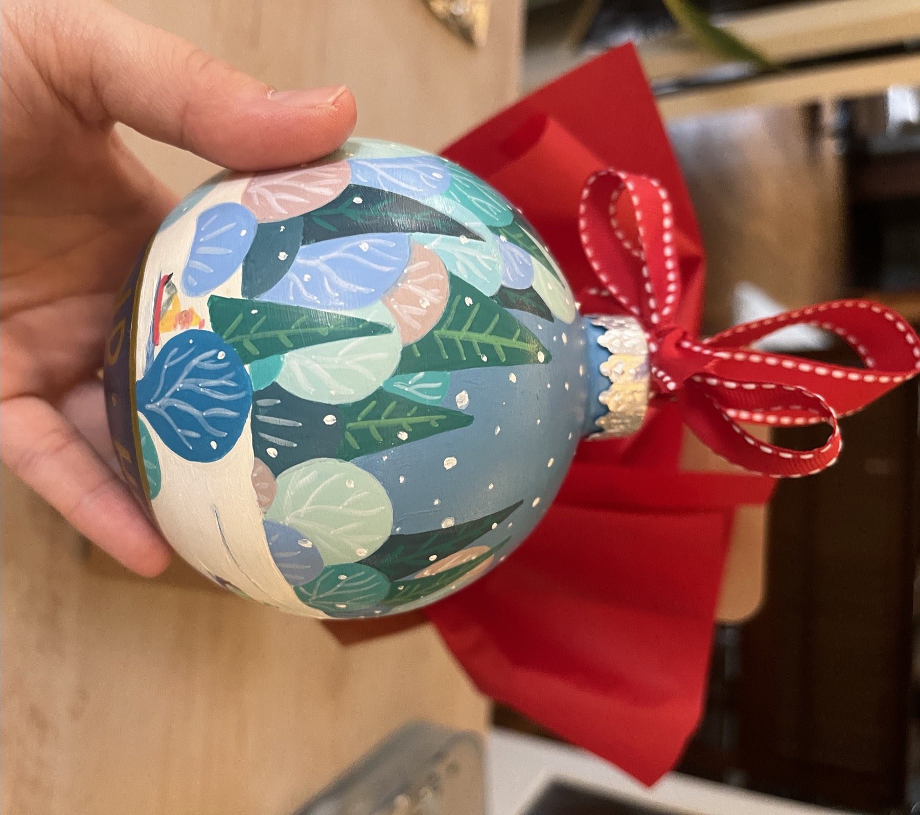 Hand-painted Cleveland Heights ornament with layered leaves and homes